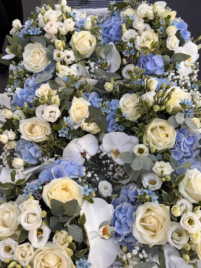 Coussin de deuil en roses blanches, orchidées et hortensias bleus