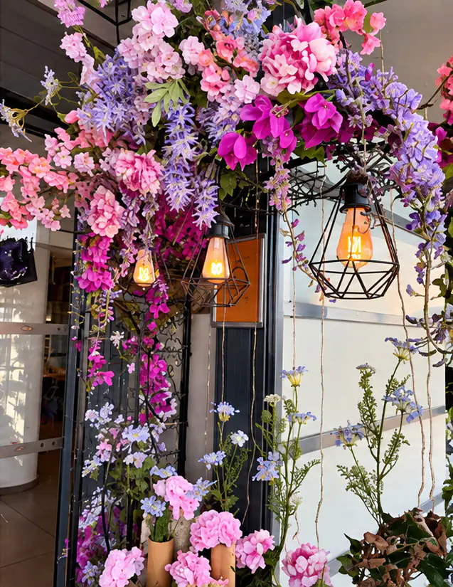 Décoration florale d'entrée avec suspensions de glycines et luminaires